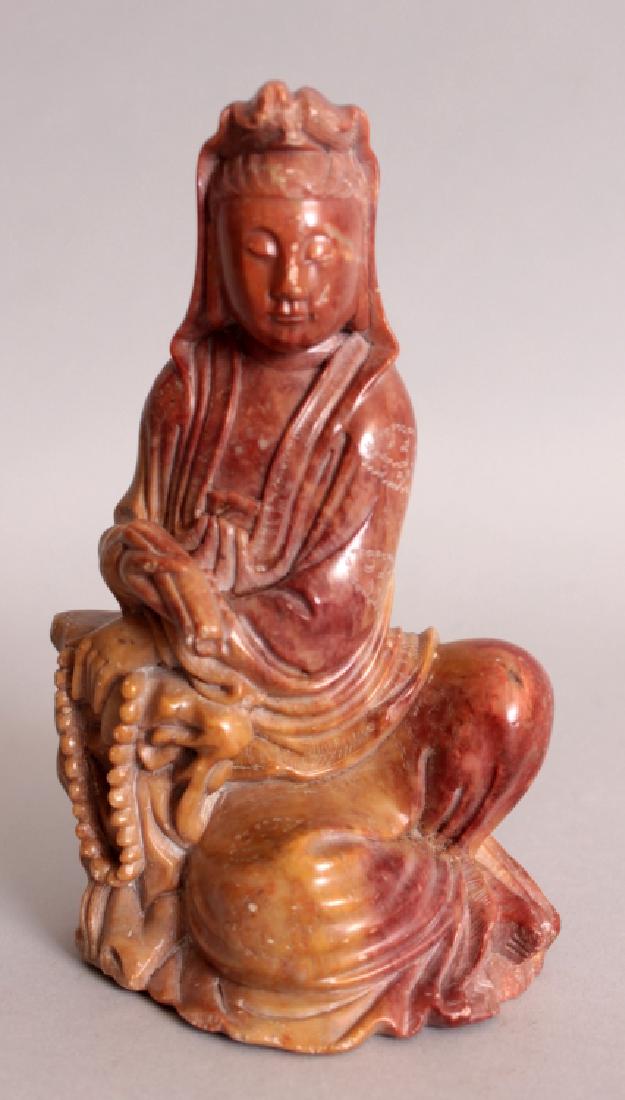 A 19TH/20TH CENTURY CHINESE SOAPSTONE FIGURE OF: A 19TH/20TH CENTURY CHINESE SOAPSTONE FIGURE OF GUANYIN, reclining against a rockwork plinth and holding a scroll, 6in high.