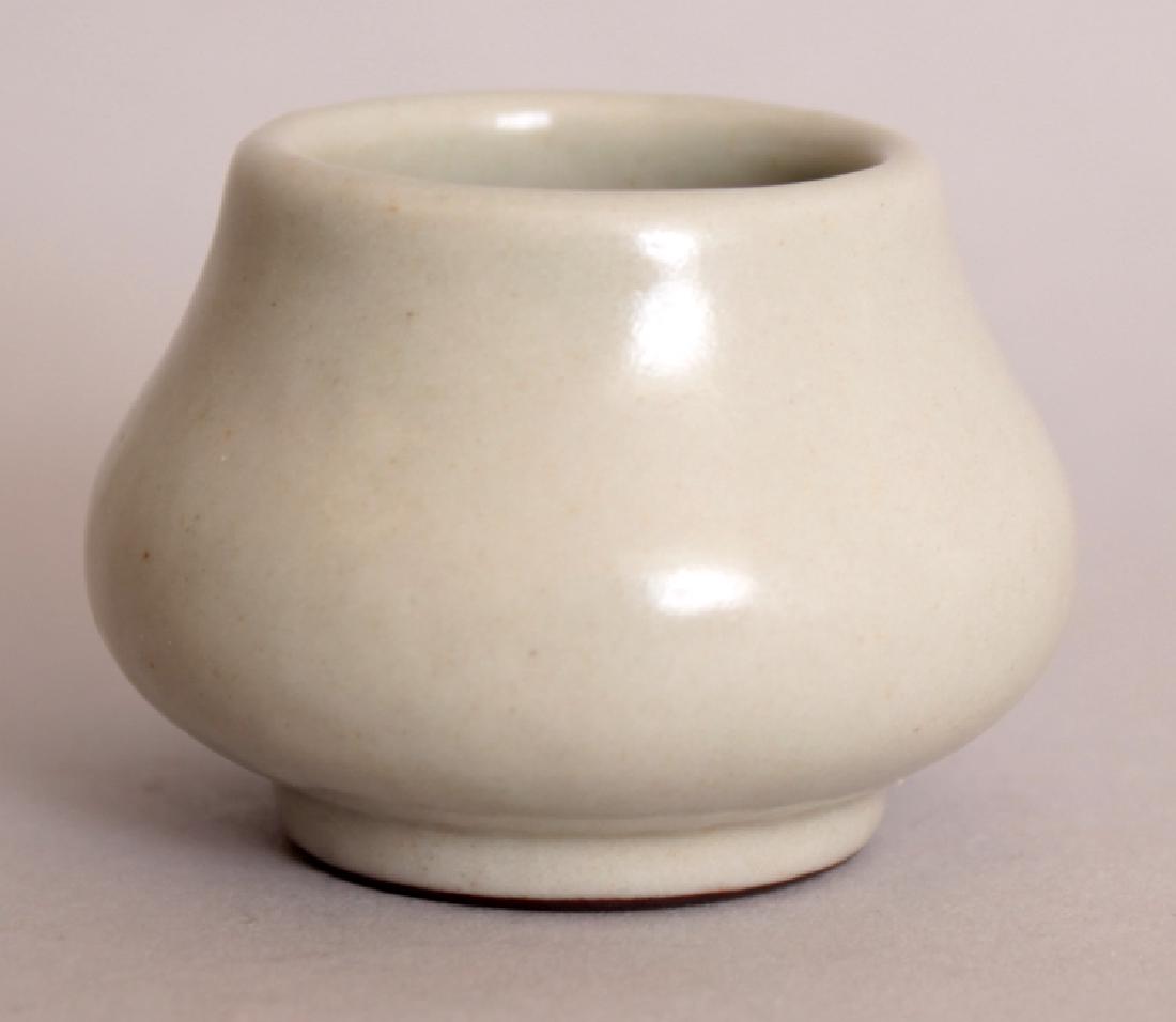 A SMALL CHINESE CELADON PORCELAIN JAR, the base with a (1 of 4)