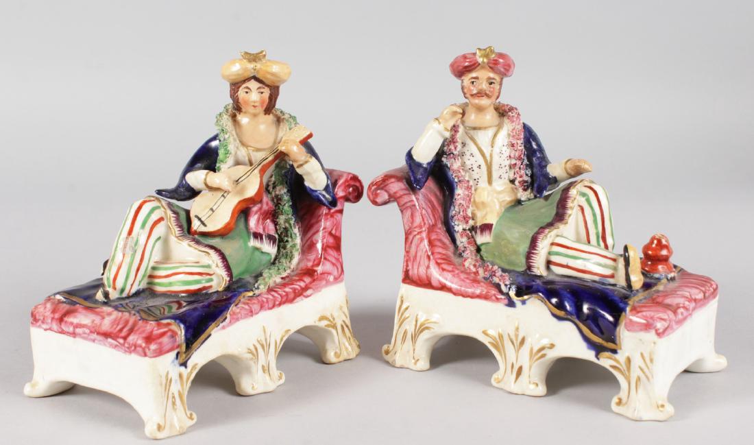 A 19TH CENTURY RARE STAFFORDSHIRE PAIR OF TURKS SEATED: A 19TH CENTURY RARE STAFFORDSHIRE PAIR OF TURKS SEATED on chaise longue chairs. 5.5ins wide.