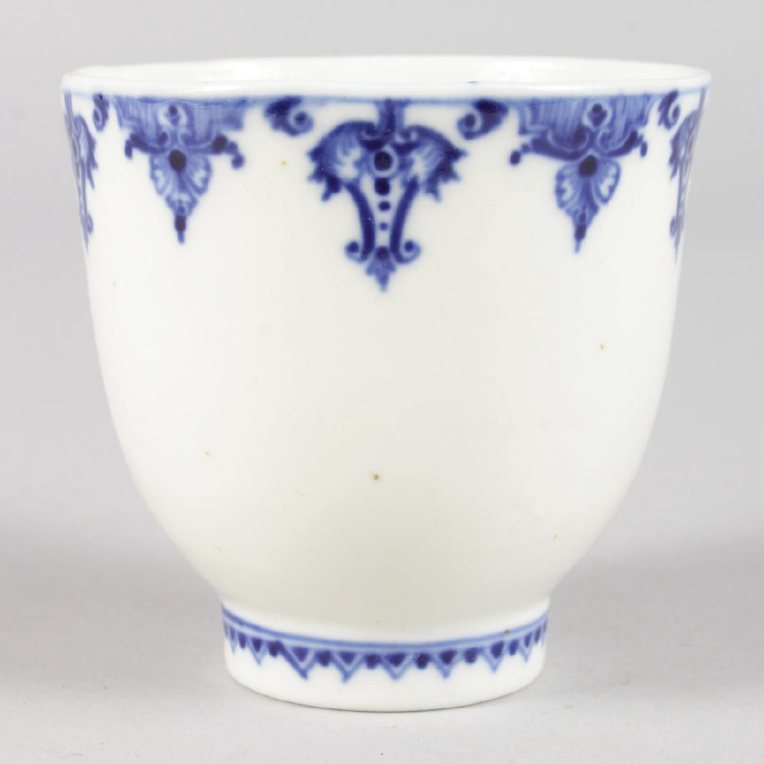 AN EARLY 18TH CENTURY ST. CLOUD RARE BEAKER of turned: AN EARLY 18TH CENTURY ST. CLOUD RARE BEAKER of turned shape painted in underglaze blue with lambrequins. 2.75ins tall.
