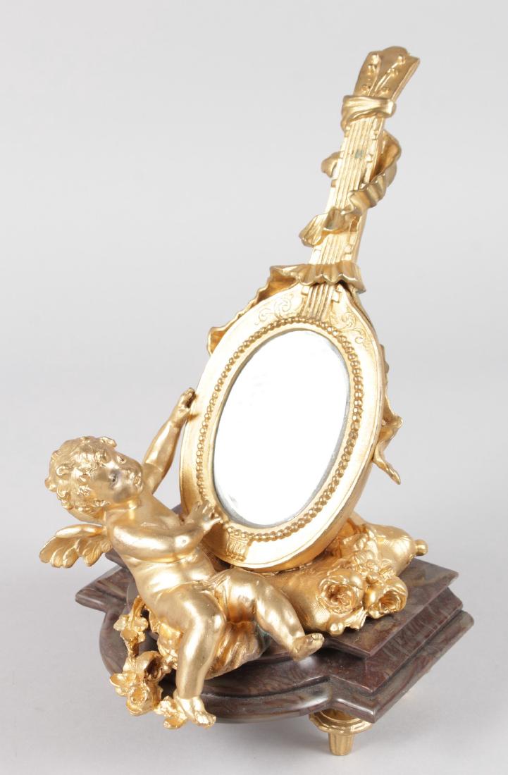 A 19TH CENTURY FRENCH ORMOLU AND MARBLE MIRROR in the: A 19TH CENTURY FRENCH ORMOLU AND MARBLE MIRROR in the form of a cupid holding a guitar, on a shaped marble base. 12ins high.