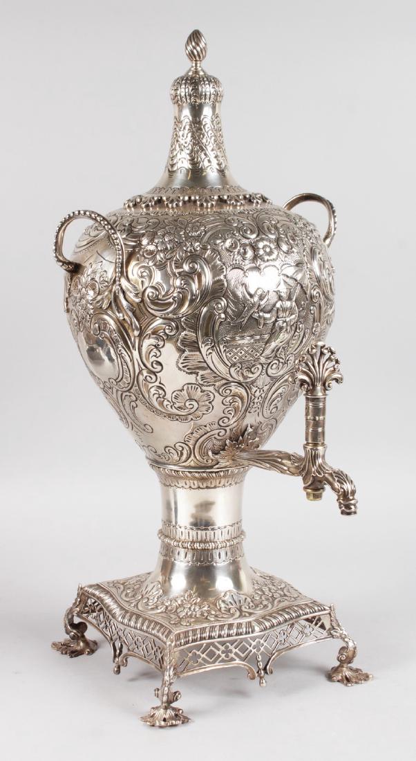 A SUPERB GEORGE III SILVER SAMOVAR AND COVER with: A SUPERB GEORGE III SILVER SAMOVAR AND COVER with Chinese decoration, flowers and scrolls with carrying handles, top, on a base with fretwork carving and claw feet. London 1768. Maker: B. Blanez.
