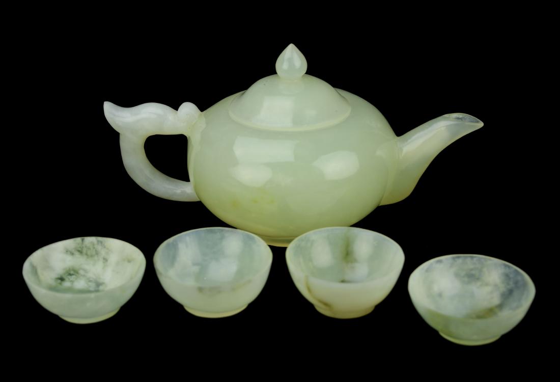 A Greenish White Jade Carved Tea Sets ( 1 Teapot x 4: A Greenish White Jade Carved Tea Sets ( 1 Teapot x 4 Cups) | 青白玉雕茶具組 (1壺4杯) Dimensions: 8x4x4.25" for the pot