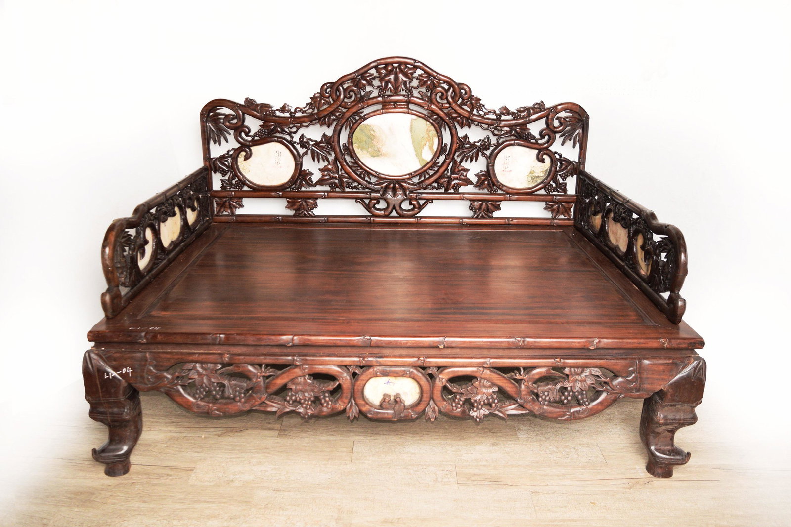 A Chinese Old Hardwood Arhat Couch Bed Carved with: A Chinese Old Hardwood Arhat Couch Bed Carved with Grape Vine and Bamboo and Inlaid with Marbles | 老紅木雕葡萄竹紋鑲雲石羅Ĝ