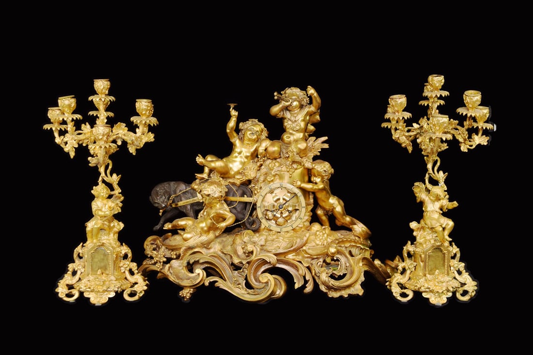 A Set of Gilt Bronze "Three Cherub with Horns" Figural Mental Clock and a Pair of Candelabras (1 of 11)