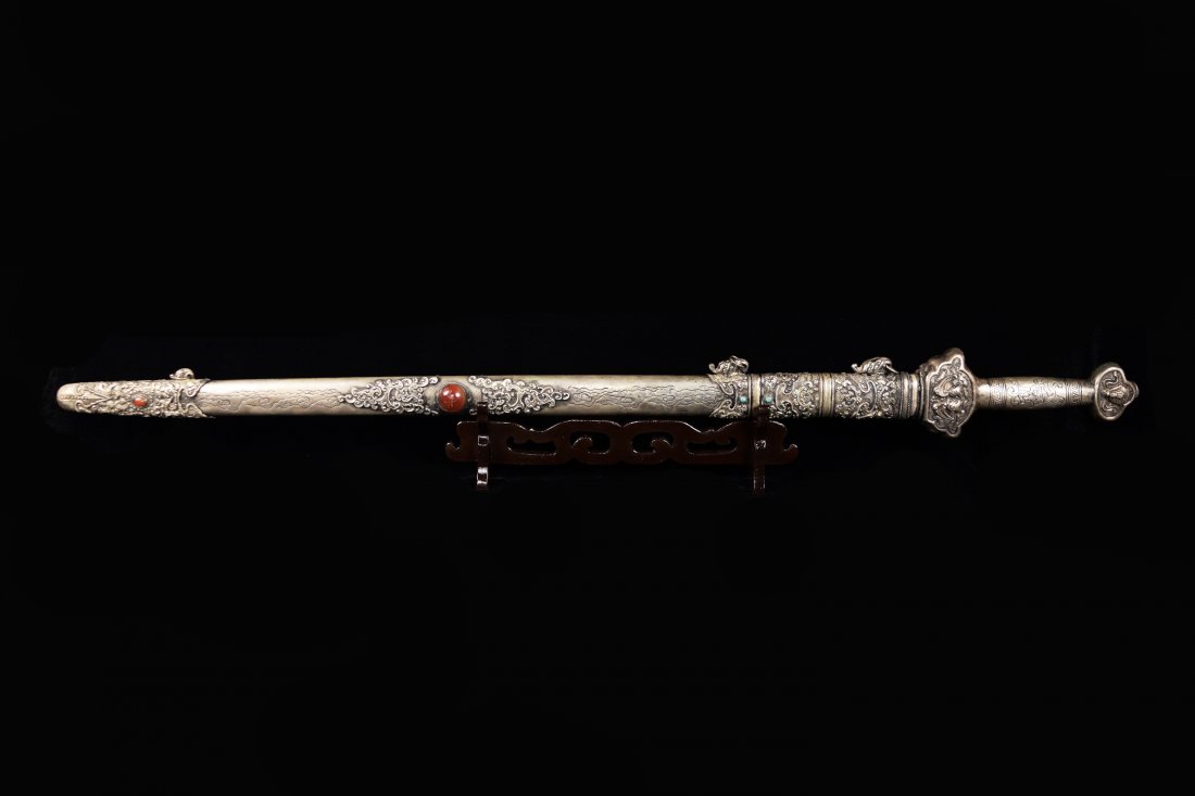 An Old Chinese Sword with Silver Plated Scabbard: An Old Chinese Sword with Silver Plated Scabbard Studded with Agates and Turquoise, marked as "Dragon Sword" on the Blade ｜鎏銀雕海水雲福紋໲