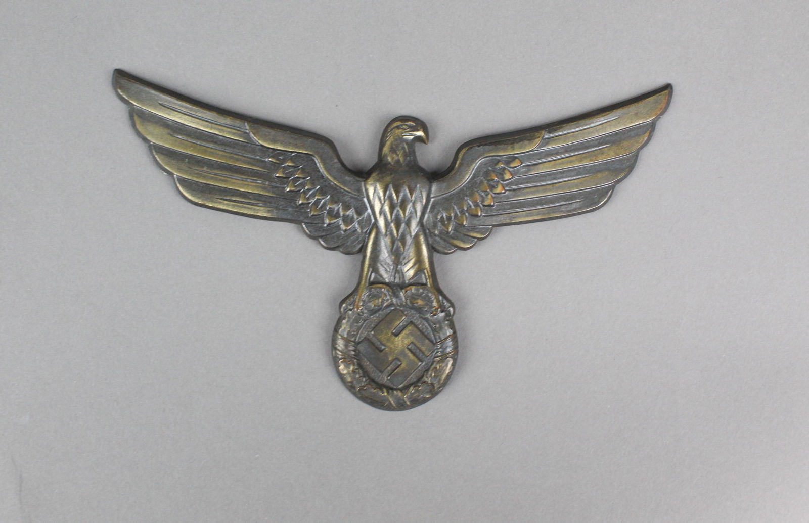 WWII Nazi SS Large Eagle Pin: WWII Nazi SS Large Eagle Pin. A large SS eagle pin that would have been on a gorget. The eagle and swastika have a bronze like finish that has some slight wear on the tops of the wings. No actual pins