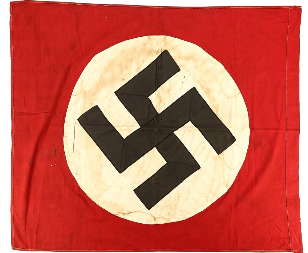 WWII Vet Bringback Nazi Party Flag: A small flag for the Nazis, designed to have a pole inserted across the top edge. Flag is a veteran bringback and has some minor moth holes and stains. Overall good condition. See photos. Measures 30.