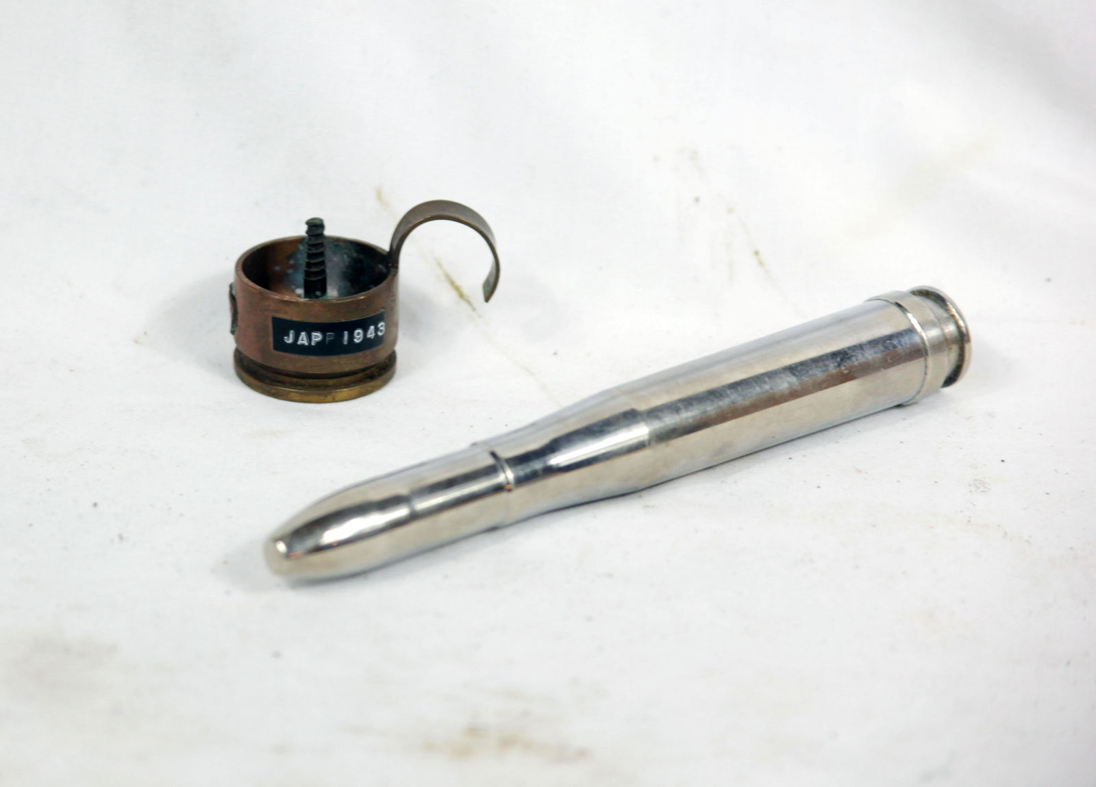 WWII Axis Germany/Japan Trench Art: Trench are includes a candle holder and chrome cartridge. Candle holder made from Japanese cannon shell. Chrome cartridge is from German 20mm cannon round. Neat vet souvenirs.