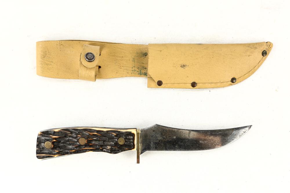 Skinny Knife: Upswept blade stamped Imperial Prov. RI USA. Antler type grip with unusual shape but fits the hand well. Blade with short serration. Vinyl sheath in good condition. Blade measures 5", overall measures