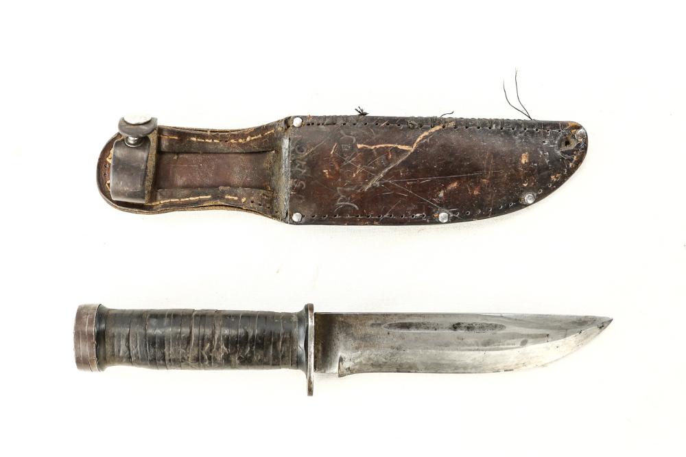 WWII Fighting Knife: Stamped Cattaraugus 2250 (model #). Extremely sharp blade. Heavy use on leather washer handle. USMC and name on leather sheath. Stitching and one rivet missing. Leather snap is good. Blade measures 5.
