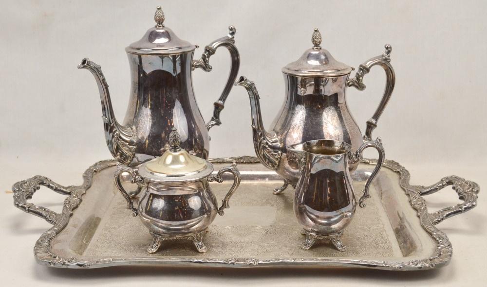 Wm. Rogers Silver Tea Set: 5 piece silver plate set in very good condition includes a heavy 2 handle serving tray measuring 15" X 24", and matching footed coffee, hot water, sugar bowl and creamer all in VG condition.
