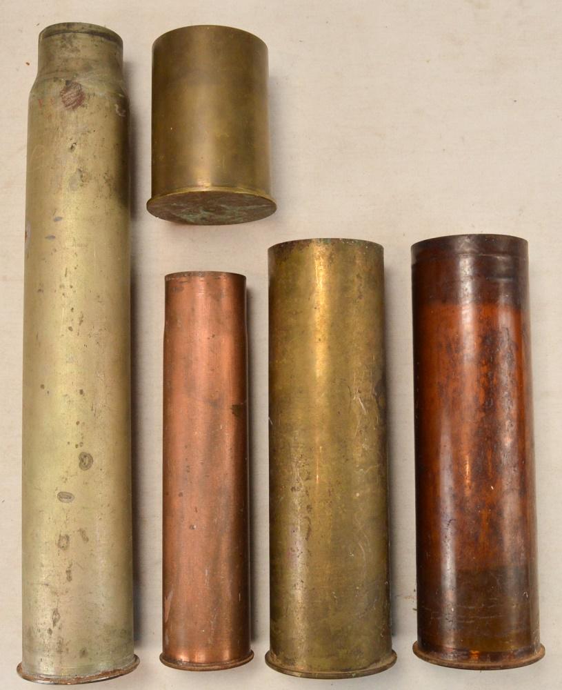 Lot of 5 Artillery Shell Casings: Lot of 5 artillery shell casings of different calibers. Lot contains 3 105mm howitzer shell casings and 2 75mm casings. Casings have rust and some of the markings are hard to read. Case lengths are di