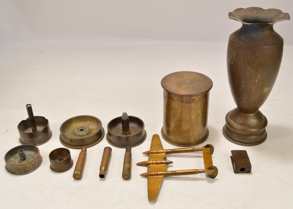 Trench Art Lot: Lot contains several trench art candle bases, a vase, and a plane among others. Trench art is in overall good condition. See photos.