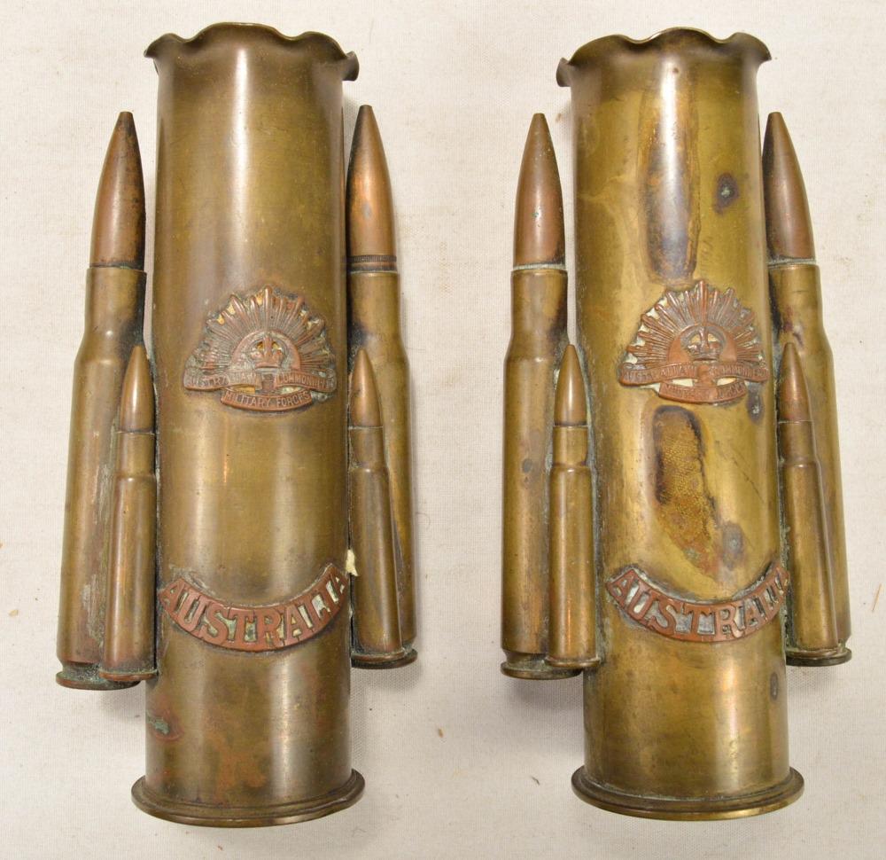 Australia Trench Art (2): Lot features a pair of trench art pieces with WWII Australian badges added on to the front. Art is made of cannon, machine gun, and rifle shells. See photos.