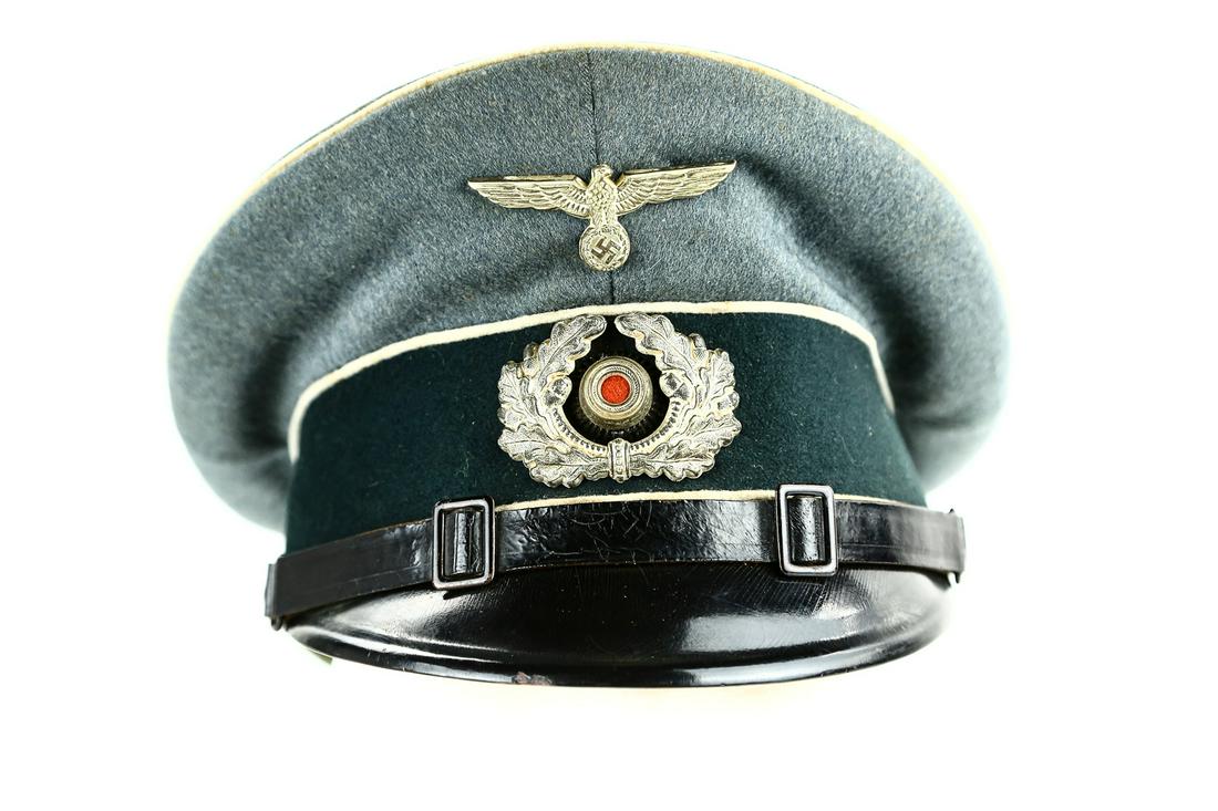WWII German Infantry NCO Visor Cap: A high quality, private purchase, visor cap for a NCO in the German Army. Cap has silver colored eagle and cockade wreath on front of cap. Insignia is slightly tarnished from age. Inside of cap is mar
