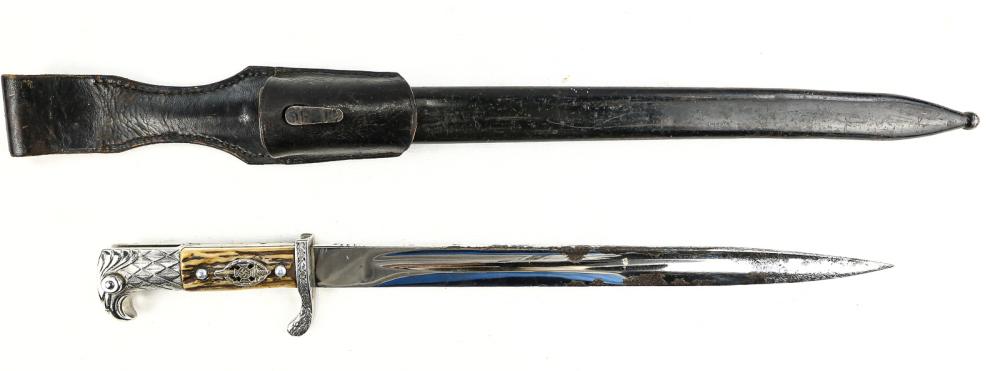 WWII German NSKOV Bayonet: NSKOV slotted dress bayonet with frog marked "Eickhorn Solingen”. Blade has heavy corrosion, factory edge, good tip. Stag grips. Nickel eagle head pommel. Release button present and working. Guard i