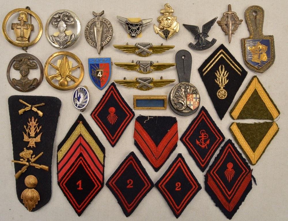 Lot of French Badges & Patches: Lot contains 29 pieces of French military insignia with insignia being a mix of patches and badges. One piece is a shoulder board with four metal pins attached. all are in good condition. See photos.