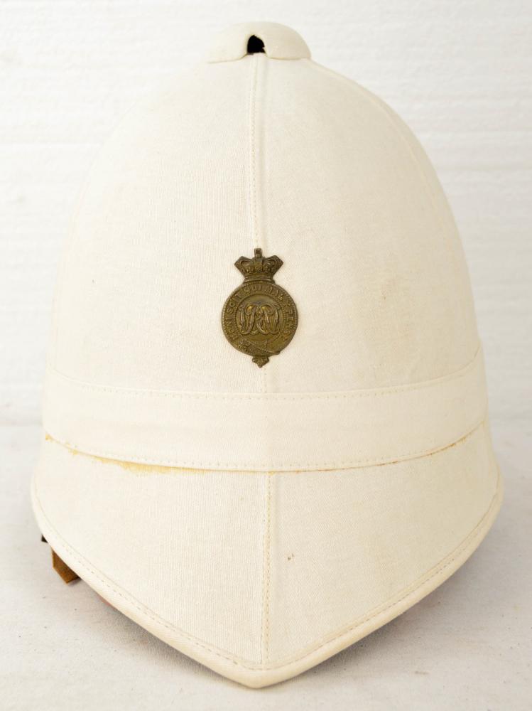 British Pith Helmet: British pith helmet. Helmet has some fading on the surface. Inside is clean. See photos. Measures 12.75” long and 9.5” tall.