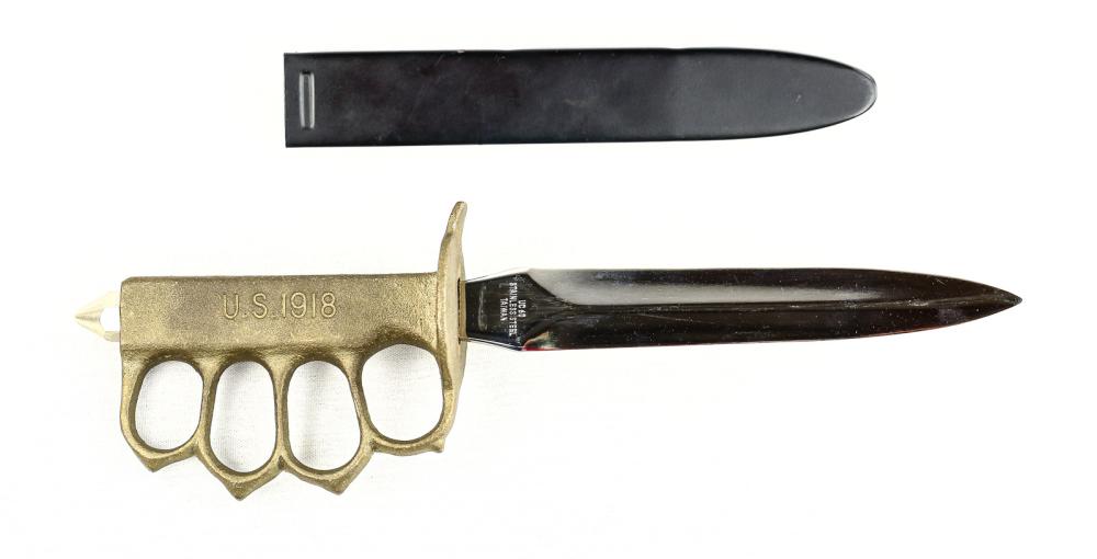 WWI US Trench Knife Replica: US WWI style trench knife replica. Blade is marked "UC 60 Stainless Steel Taiwan" near the tang on one side and United on the other. Scabbard is a little loose with the blade in. Handle shows some wea