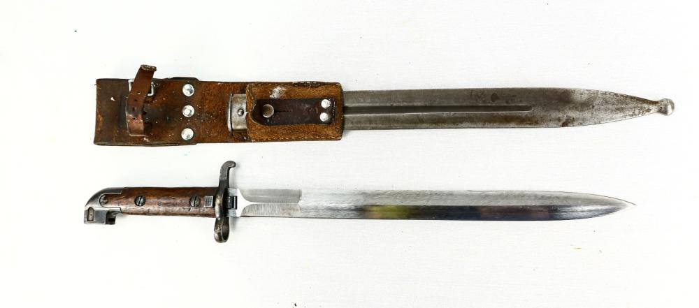 1914 Swedish Bayonet: Blade measures 13". Bright double edged blade. Well defined arsenal mark on blade. For Swedish 1894-1895 rifles. Grips, metal parts, and scabbard in very good condition. Includes leather frog with com