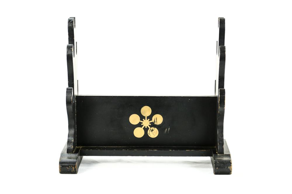 Black Wood Sword Stand: Wooden sword stand painted in black with a gold design on one side. Stand can hold 5 swords across the front, top and back. Has some wear on the edges but is in good shape. See photos. Measures 19x17x