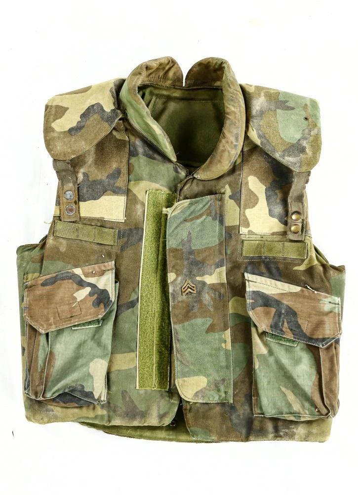 US Military Flak Jacket: A 1984 dated, woodland camo flak jacket. Fair condition for its age. Has some minor rips, tears, and scratches. Not sold as protective gear.