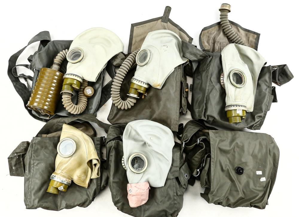 Lot of 5 Soviet Gas Masks: Lot contains 5 gas masks in carrying bags, all with hose and filter. There is an empty sixth bag included with the lot. Some masks and filters have protective paper wrapping labeled "Made in Germany".