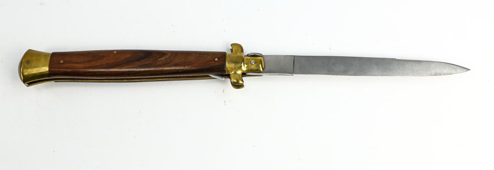 Lago Side Opening Knife: Type: Side opening. Country: Italy. Manufacturer: Iago. Release: Push button. Length: 17 3/8". Scales: Rosewood. Bolsters: Brass. Liner: Brass. Condition: New. Blade markings: "Rostfrei". No Reserve.