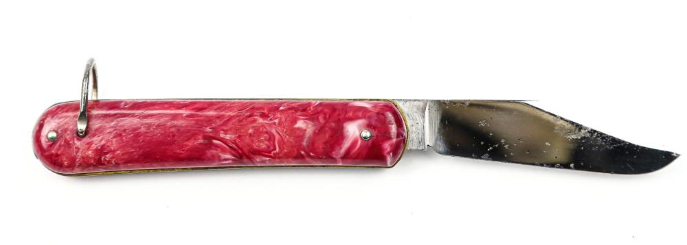 Schrade Rainbow Switch Blade (Pink): Type: side opening. Country: USA. Mfg: Schrade Knife Co. Release: push button. Length: 7 1/8". Scales: plastic multi-colored pink. Bolsters: none. Liner: brass. Tang markings: Jiffy Colonial Prov. USA