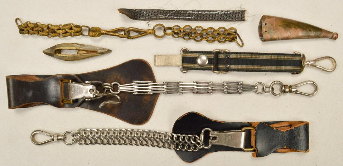 Lot of Dagger/Sword Hangers: Lot consists of 4 hangers, 2 of which are attached to leather belt attachments. Lot also contains a worn crossguard and an oxidized scabbard tip. Hangers have some signs of wear to leather. See photos