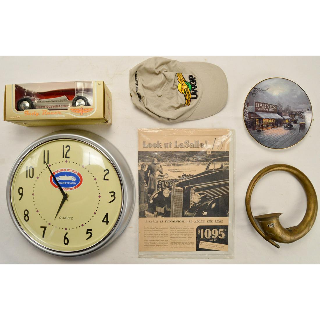 Misc. Auto, Car Contemporary Memorabilia: 6 items of Contemporary auto memorabilia. Brass horn, collectable Indy model car in box, UWGP hat, national hot rod clock, antique auto display plate and a vintage La Salle broacher. Shipping: After y