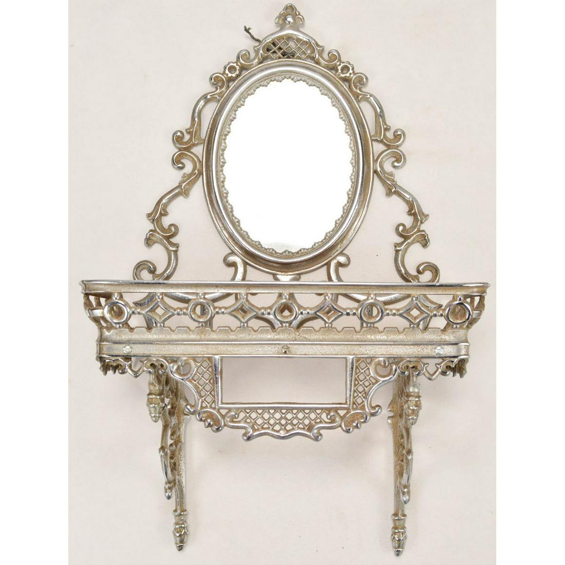 Nickel Plated C.I. Knick Knack Shelf: This unique piece has a mirrored back and a shouldered shelf, very ornate piece with no breaks to the castings. Some replacement screws. Overall measures 19" tall, 12" across, 5 1/2" deep.