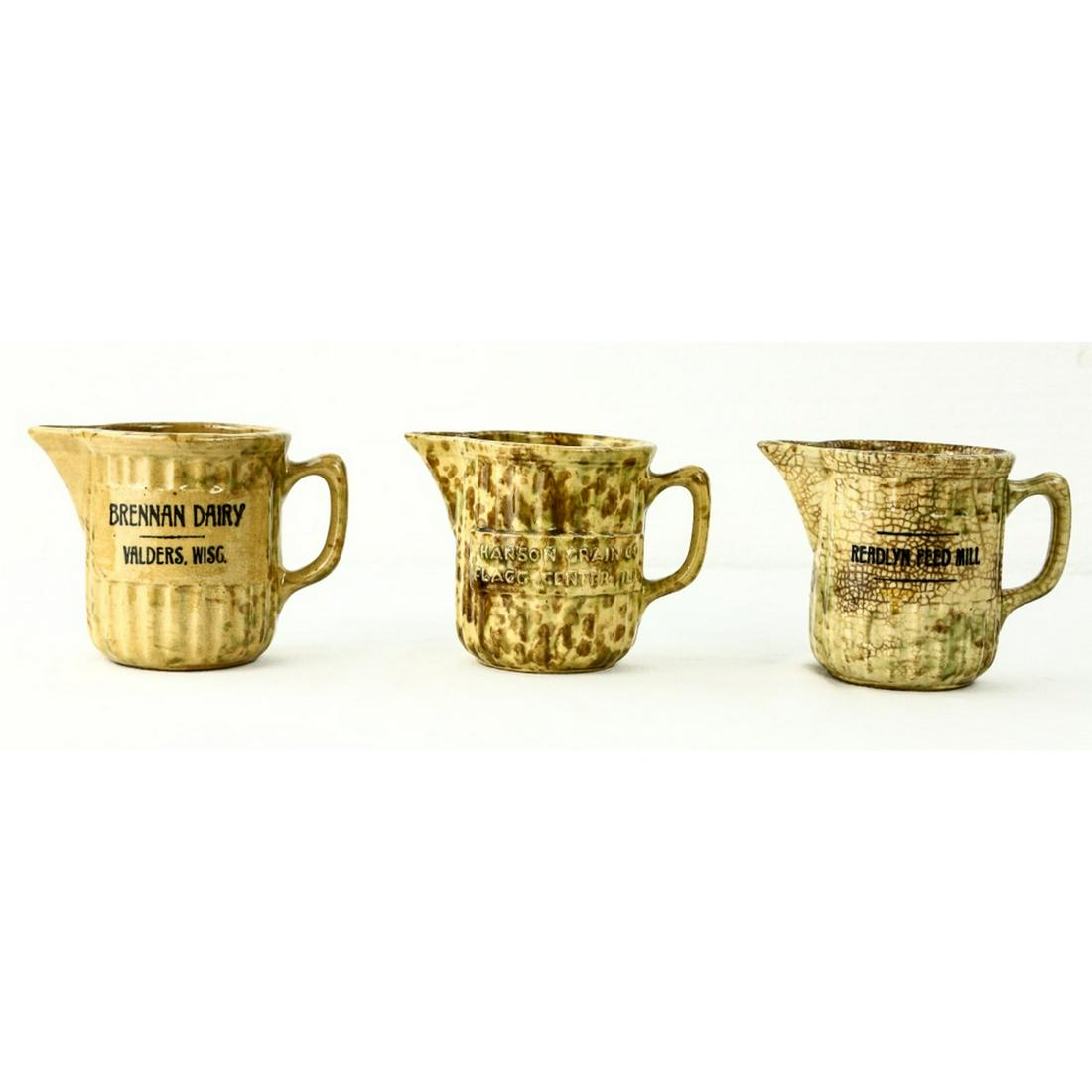 Spongeware Advertising Pitchers (3): Three stoneware pitchers for the three following companies: Readlyn Feed Mill, Brennen Dairy of Valders. WI, and Hanson Grain Co. of Flagg Center, IL. All pitchers are in good condition. See photos.
