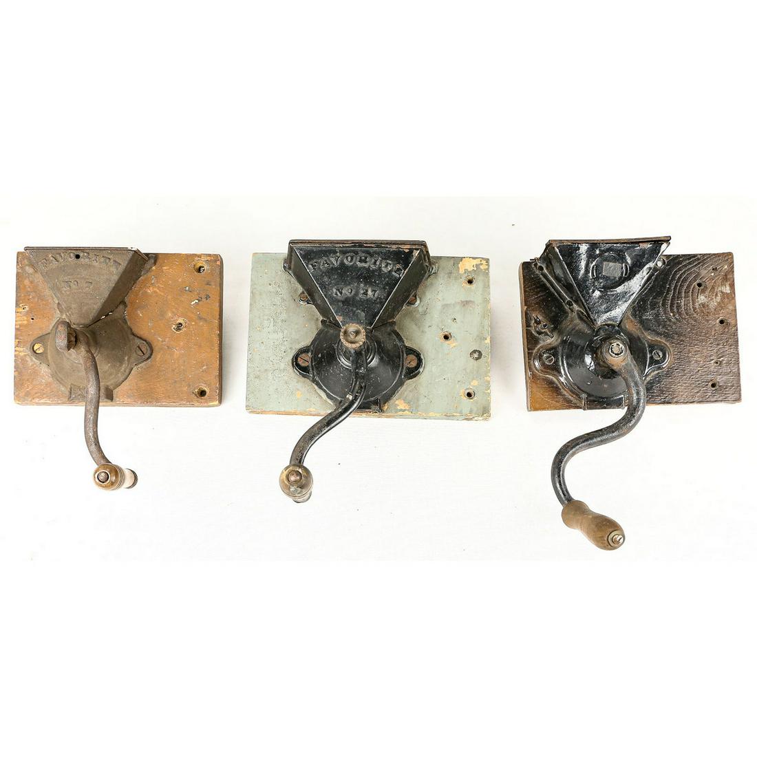 Lot of 3 Coffee Grinders: Lot of 3 Coffee Grinders. All wall mounts attached to wood boards. 1x Favorite No. 27 black painted. 1x Favorite No. 7. 1x unknown maker, black paint.
