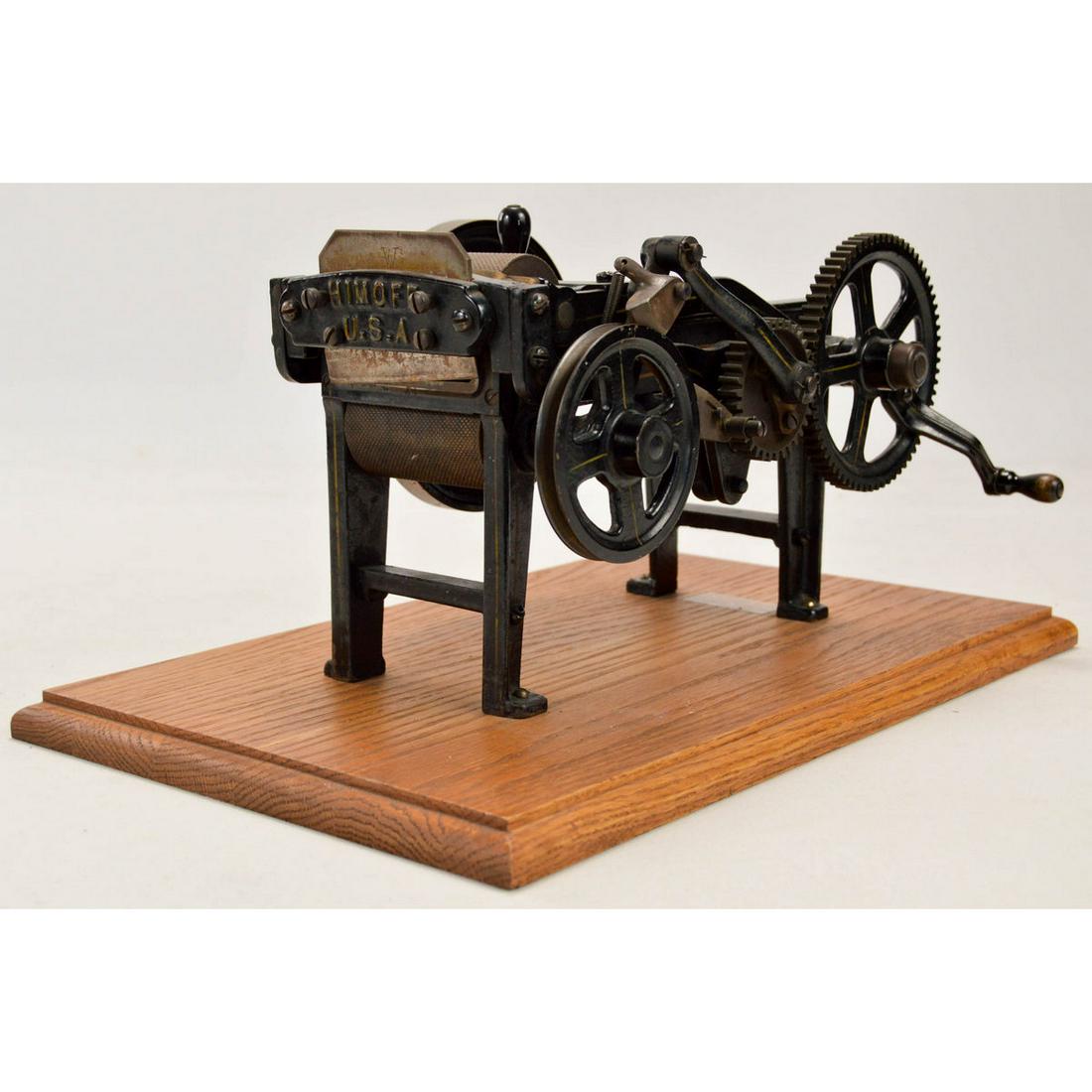 Himoff Mechanical Tobacco Cutter: Made by the Himoff Machine Company, New York, New York. Circa 1908. Belt driven and hand cranked cast iron machine. Used for automatic cutting of plugs of tobacco. In overall good original condition,