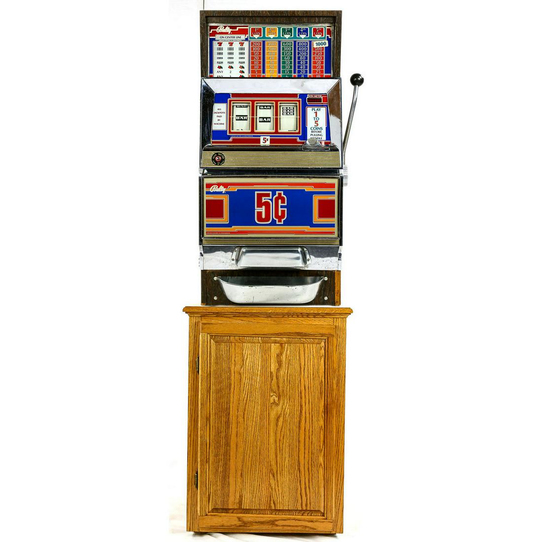 Bally Electronic Slot Machine & Stand: Contemporary 5 cent Bally steel slot machine with multiple pay-outs. A beautiful machine that lights up and will pay out large amounts. Has a very nice cabinet, glass, and chrome. Along with this is a