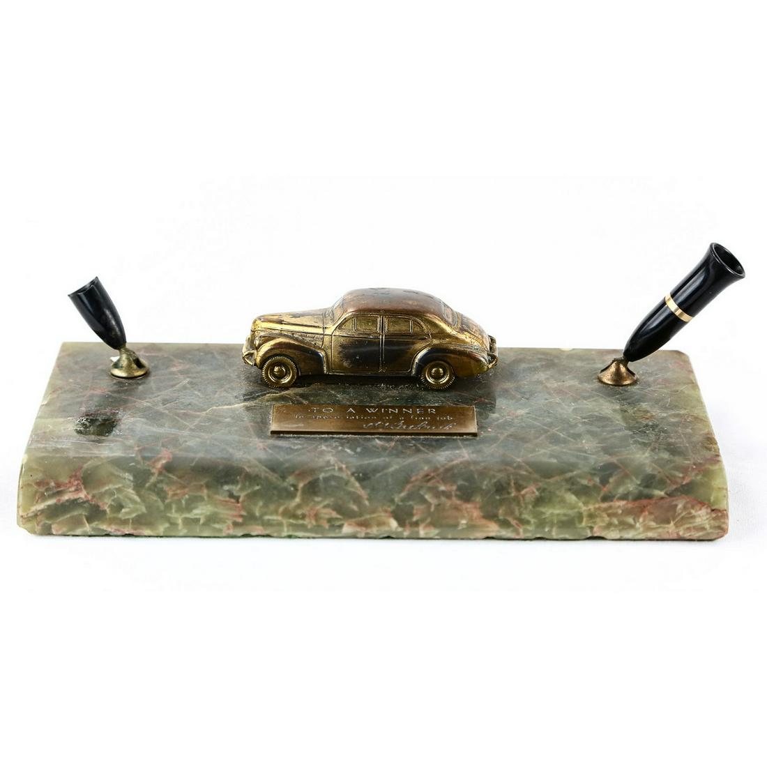 Sheaffer Automobilia Fountain Pen Desk Set: Sheaffer Fountain Pen Desk Set, pens not included, 1940's Pontiac displayed on top, one of the pen holders is broken, base is made of either onyx or marble, 10" x 5", see photo.