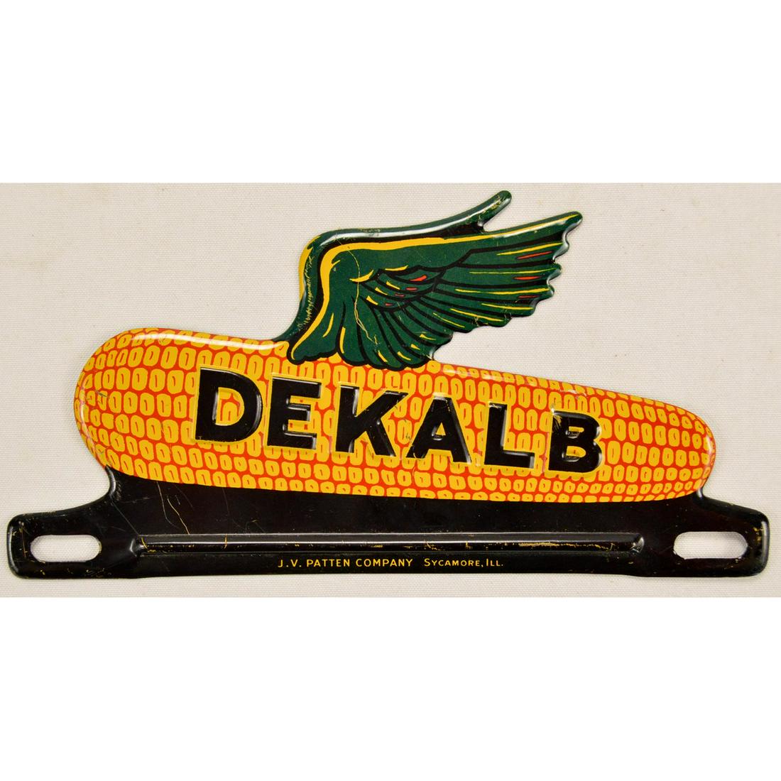 DeKalb Corn License Plate Topper: DeKalb Corn License Plate Topper Embossed tin litho Made by J.V. Patten Co. Sycamore IL Overall very good condition with a few minor scratches. Measures 8.25" wide and 4" tall