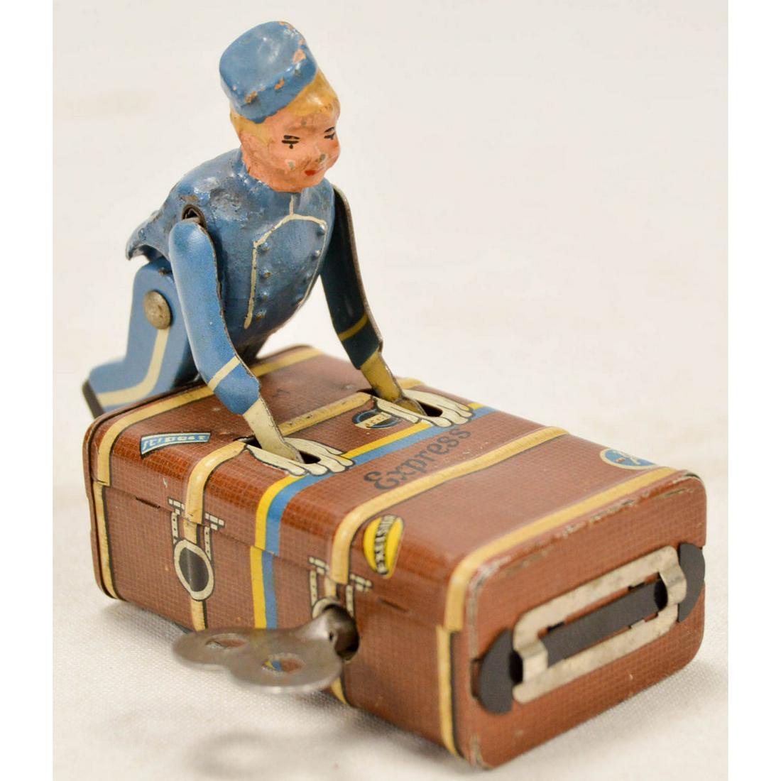 Gescha Vintage Tin Windup Toy Bellhop w/Luggage: Gescha Vintage Tin Windup Toy Bellhop w/Luggage, "Patents applied for in England U.S.A. France & Japan" stamped on bottom, Paint is in overall good condition with some wear and rubbing, Windup works a