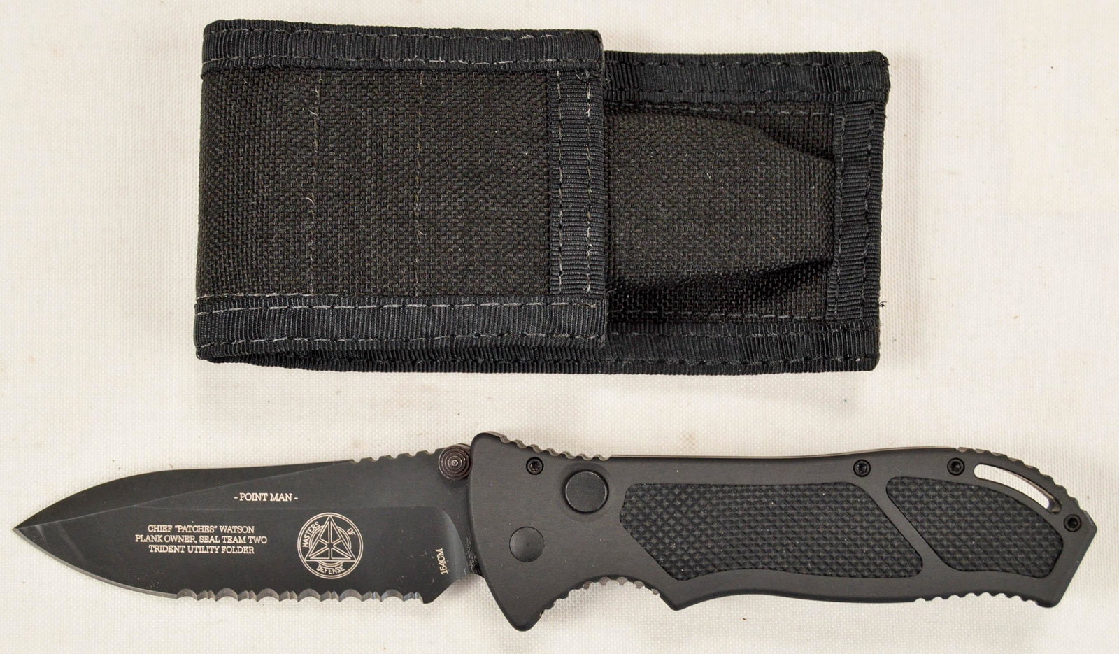 Masters of Defense "Patches" Trident Utility Knife: Masters of Defense "Patches" Trident Utility Knife. Automatic release blade. Etched on one side of blade is Chief "Patches" Watson Plank Owner, Seal Team Two, Trident Utility Folder. 154cm etched on b