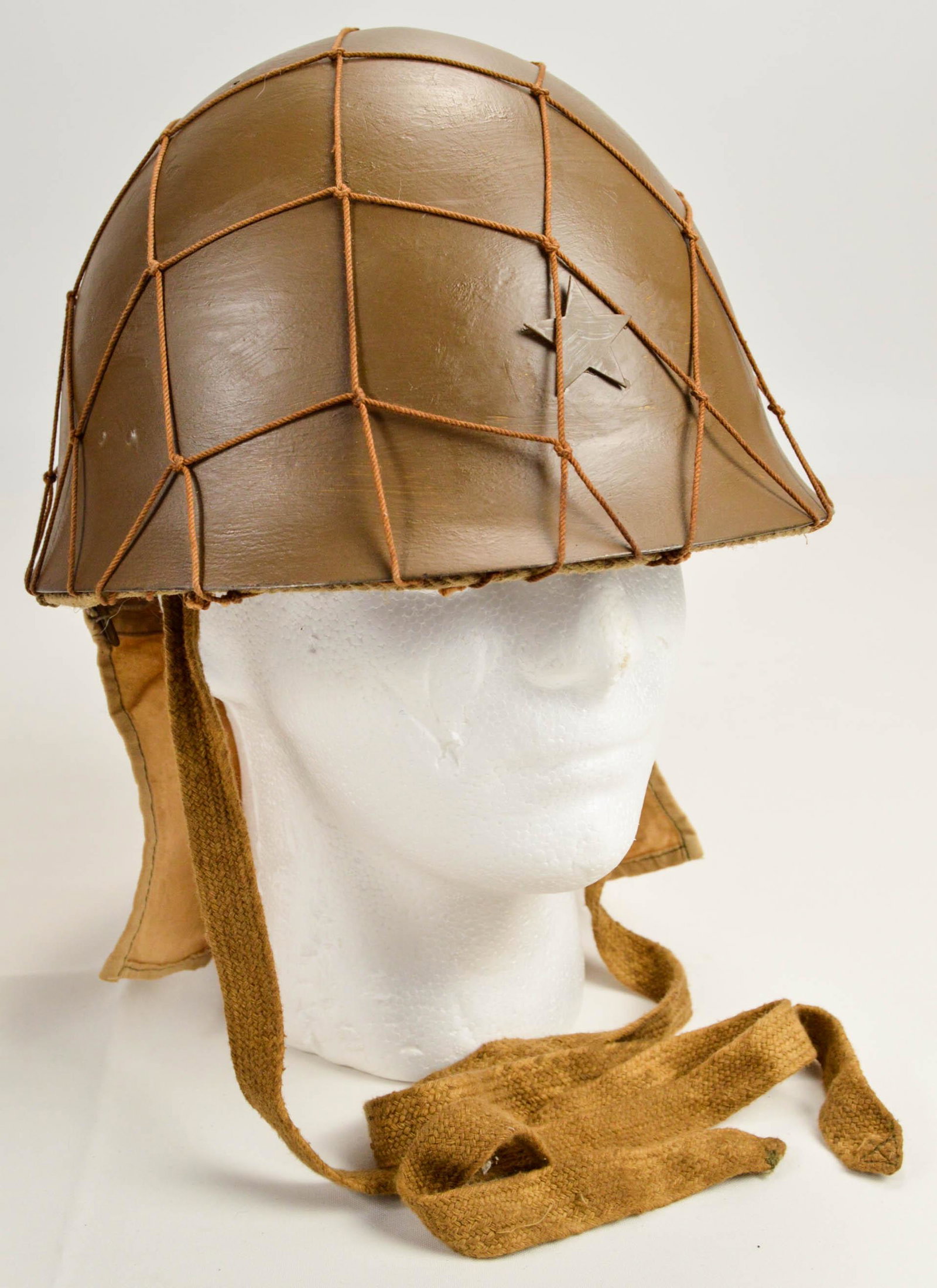 WWII Japanese Army Helmet w/ "Camo" Netting: WWII Japanese Army Helmet w/ "Camo" Netting. Also includes "Sun Burn" neck flap with liner and chin straps. We were told this was a reproduction, you be the judge. See photos.