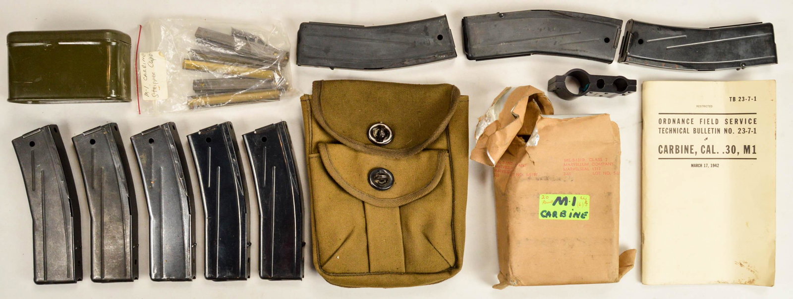 Lot of M-1 Carbine Magazines Ammo Clips Book: Lot of M-1 Carbine Magazines Ammo Clips Book. Includes Ordnance Field Service Technical Bulletin No. 23-7-1 for Carbine, Cal .30, M1 published March 17, 1942. Also includes Tin with 9 M1 Carbine strip