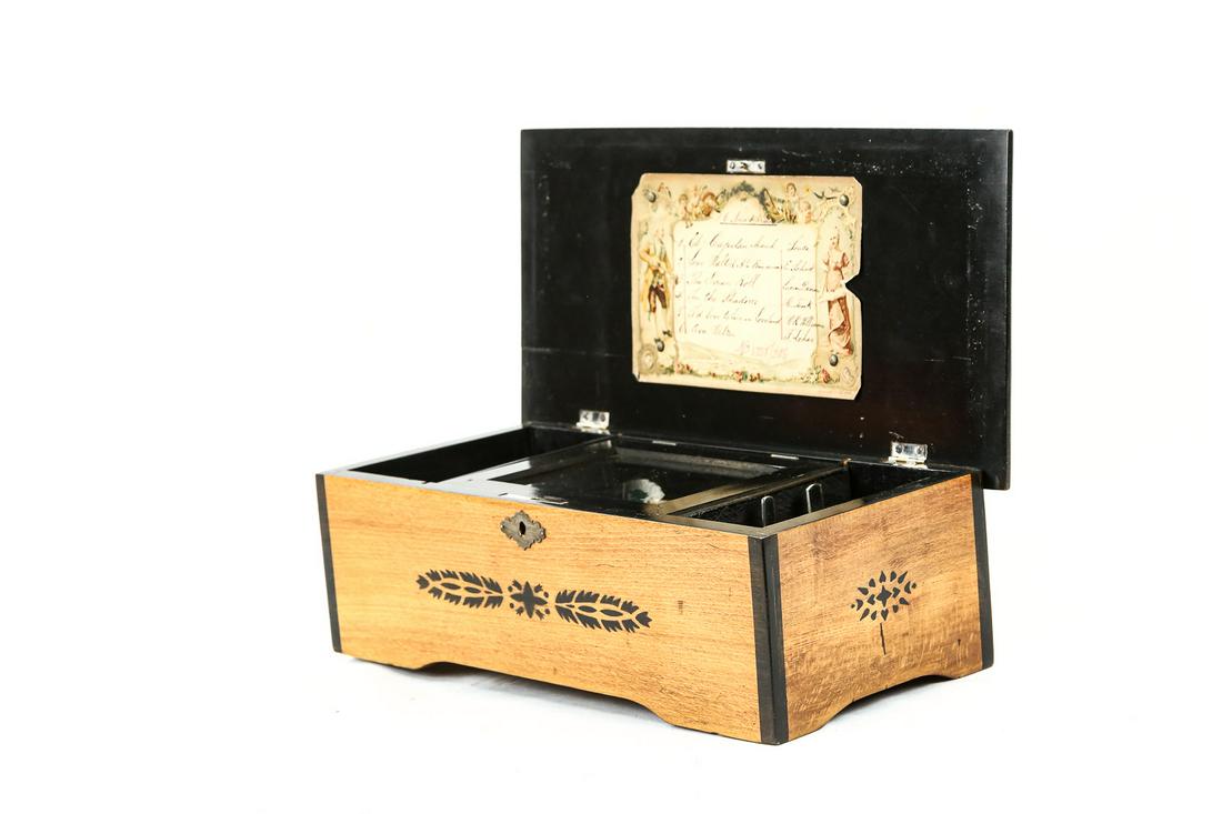 Cylinder Music Box - 6 Tune: Vintage Swiss cylinder music box that plays 6 different tunes. Winds and plays beautifully. No chipped or broken teeth. Wood case has nice ethnic Swiss stenciling and is in VG condition. No key for lo