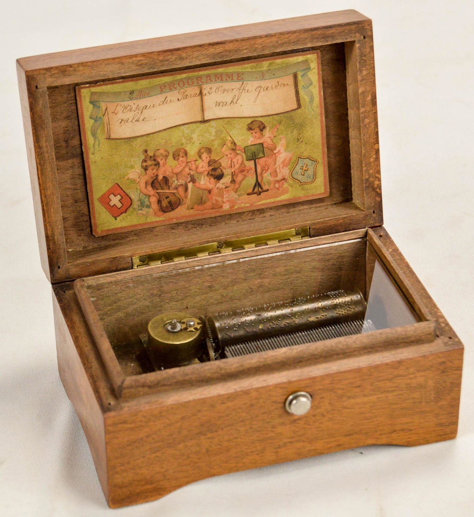 Vintage Swiss Small Wood Music Box: Small mahogany wood music box working and in very good condition. Missing only a small Swiss medallion on top of exterior. 2-3/4" high 5-1/2" wide 3-1/2" deep.