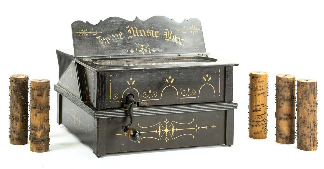 Home Music Box Cobb Organette: Made in the late 19th century and stenciled Home Music Box, this tabletop hand crank 20 note organette uses an interchangeable 6.375" wood cobb with steel pins playing one tune per cobb. There are 6 c
