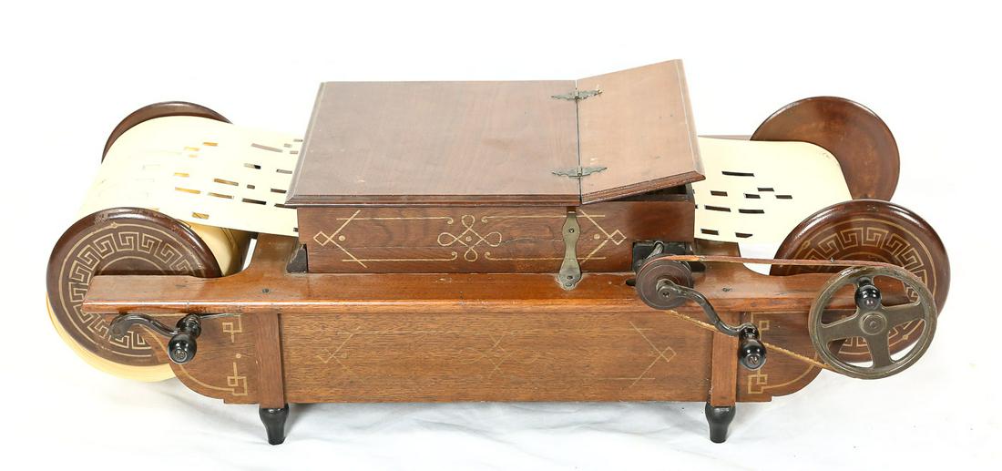Mechanical Orguinette Co. Hand Crank Spool Organ: Manufactured by the Mechanical Orguinette Co. of New York in the 1880's, this hand crank table top roller organ features a spool fed 14 note paper roll featuring 24 different songs. The all wood cabin