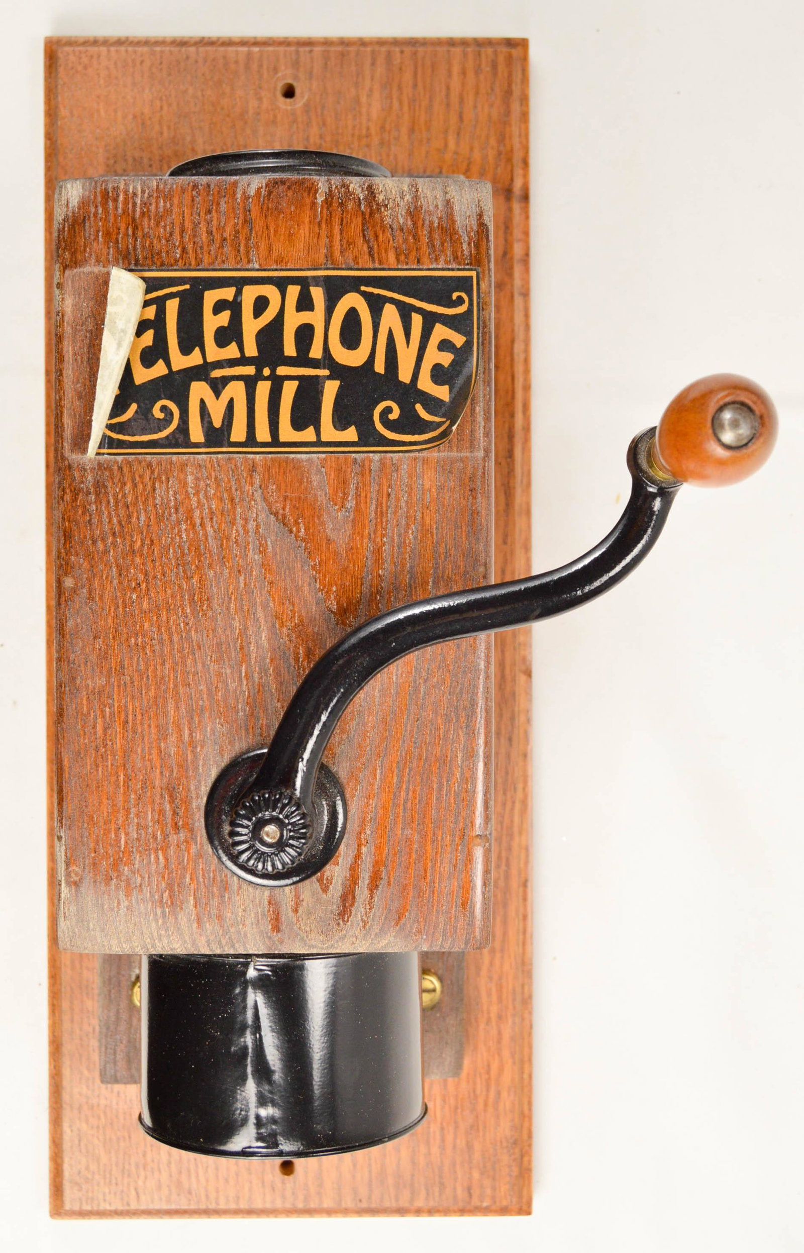 Telephone Mill Wall Coffee Grinder: Telephone Mill coffee grinder with older restoration. Replacement decal peeling off of wood case. Replacement grounds cup.