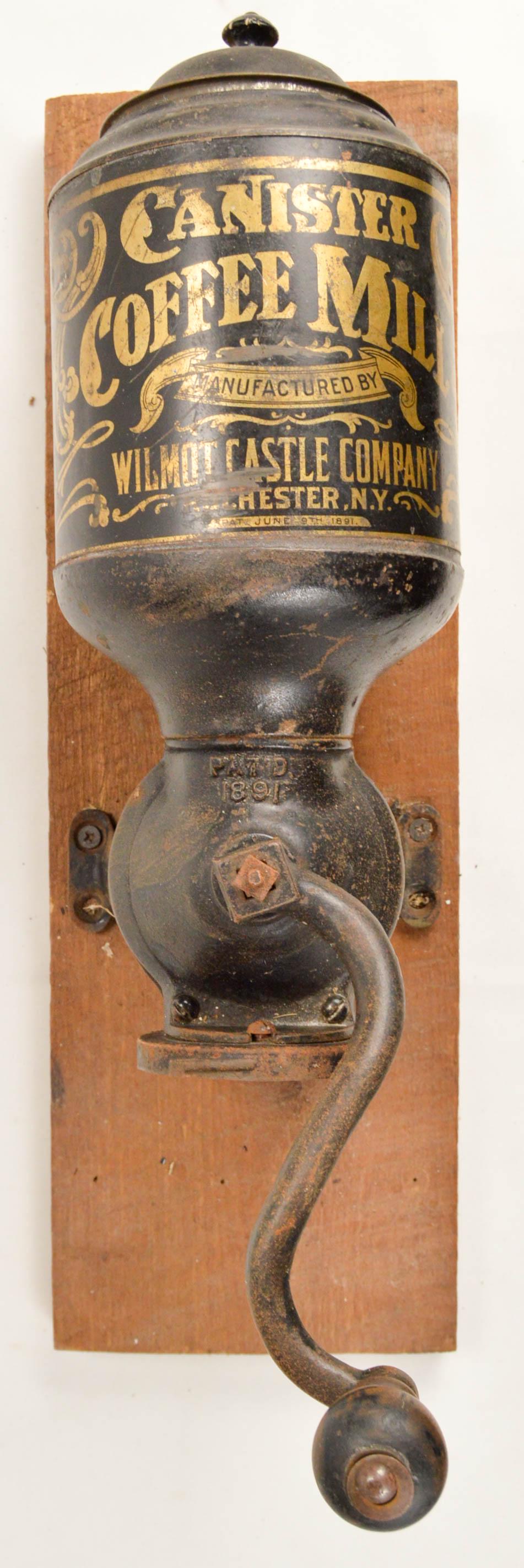 Canister Coffee Mill Wall Grinder: Nice original Canister Coffee Mill mfg'd by Wilmot Castle Co. Westchester New York. Original tin hopper has great graphics and original lid. Missing tin bayonet lock grounds cup