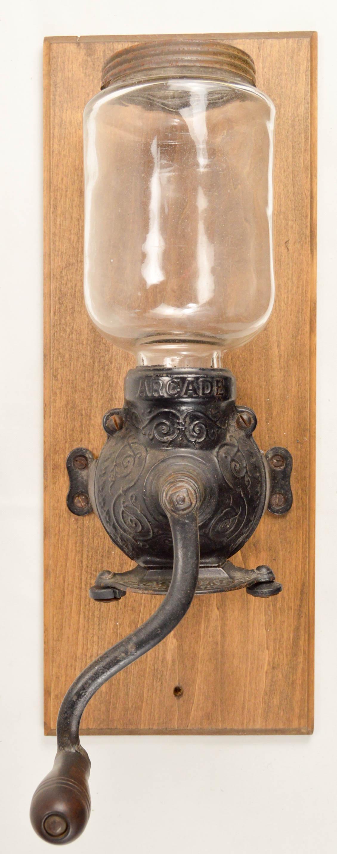 Arcade Wall Coffee Grinder: Wall mount hand crank coffee grinder made by the Arcade Mfg. Co. of Freeport Illinois. This is an Arcade Crystal No. 2. In good condition. Hopper has no chips or cracks and retains original top screw 